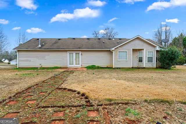 a front view of a house with yard and garage