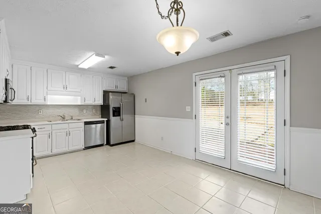 a view of a kitchen with a sink and a refrigerator