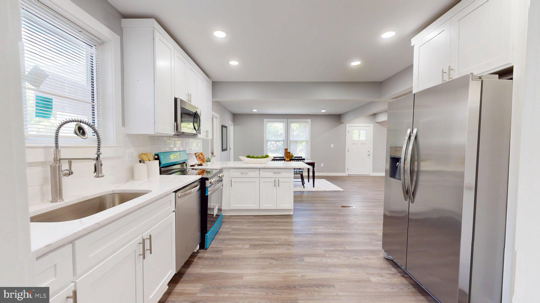 5728 Clover Road Baltimore, MD 21215 - Photo 15 of 37 Modern kitchen w/ sleek finishes + Quartz Counters