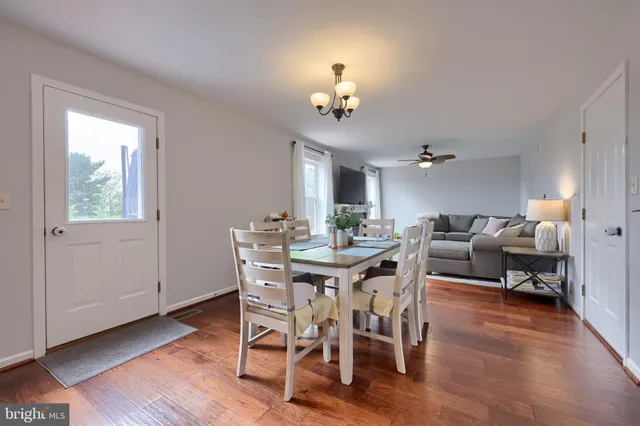 a view of a dining room with furniture wooden floor and chandelier