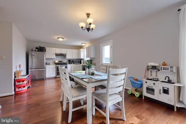 a view of a dining room with furniture and wooden floor