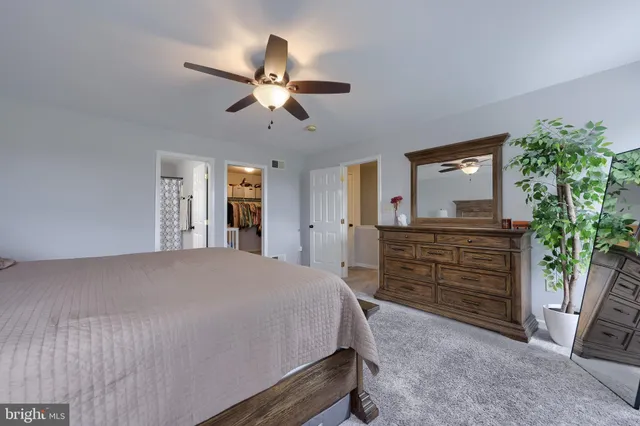 a bedroom with a bed and a dresser