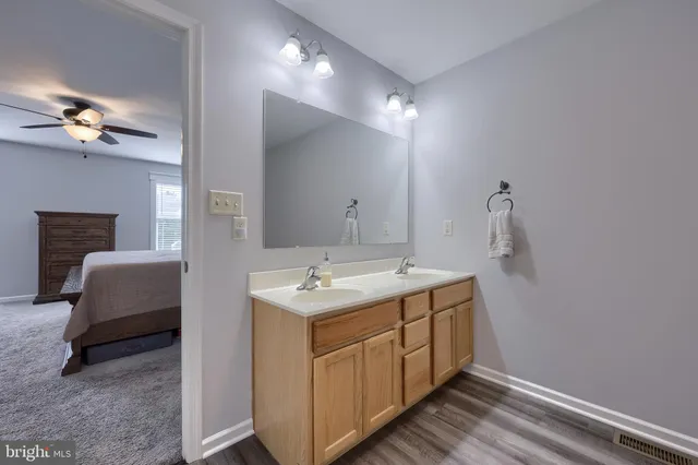 a bathroom with a double vanity sink and a mirror