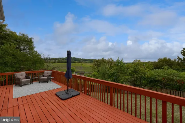 a view of a balcony with mountain view and wooden floor