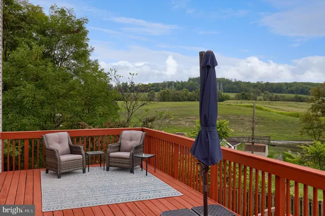 a view of a patio with wooden floor and outdoor seating
