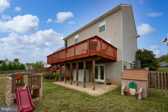 a view of a house with a yard balcony and furniture