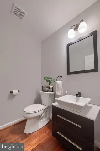 a bathroom with a sink a toilet and mirror