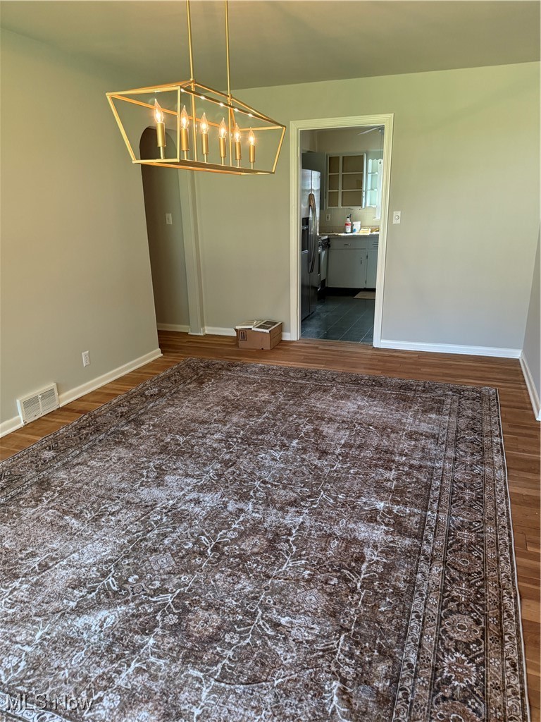 2520 Holgate Road Akron, OH 44313 - Photo 12 of 41 Dining room featuring dark wood-type flooring and a chandelier