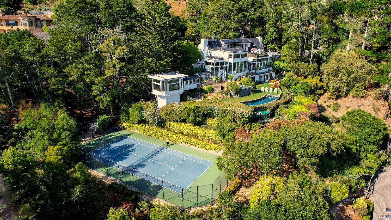 an aerial view of a house with a yard swimming pool outdoor seating