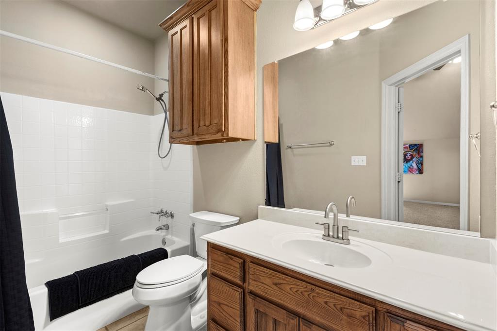 105 Country Ridge Court Red Oak, TX 75154 - Photo 31 of 40 a bathroom with a granite countertop sink toilet and mirror