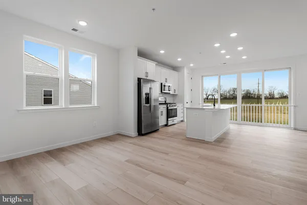 a view of a kitchen with a sink and a refrigerator