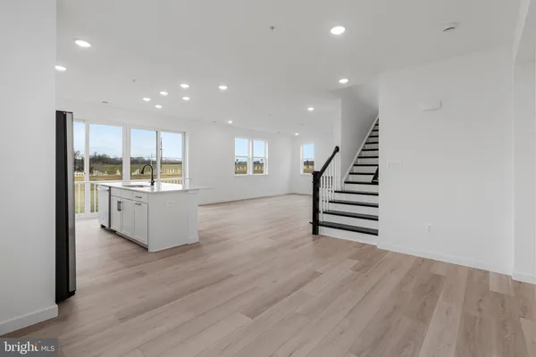 a view of kitchen with wooden floor and electronic appliances