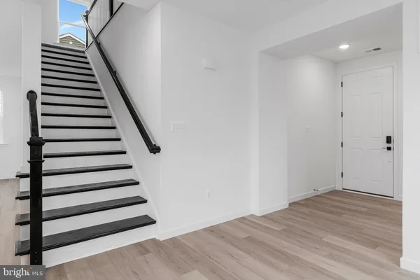 a view of a room with stairs and wooden floor