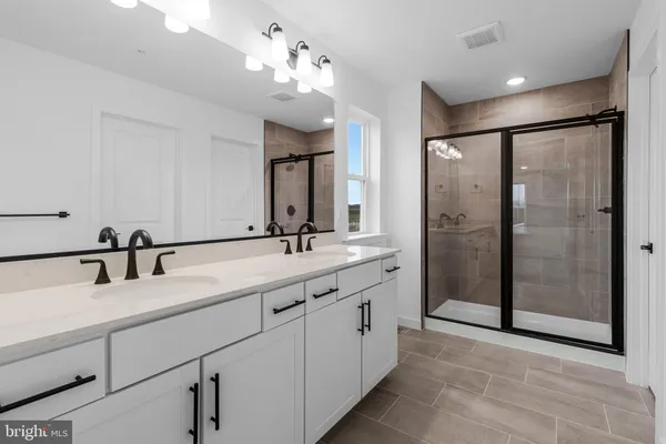 a bathroom with a glass shower door
