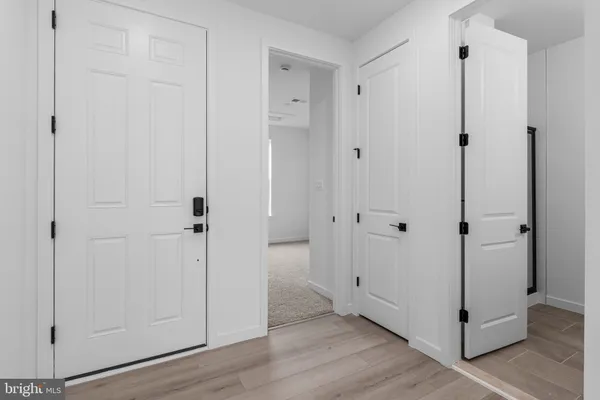 a view of a hallway with wooden floor