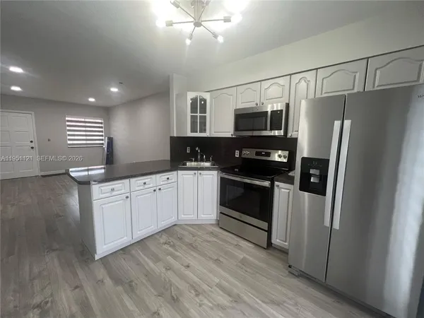 a kitchen with a refrigerator and a sink