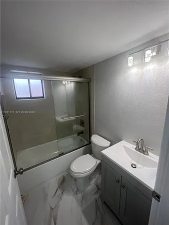 a bathroom with a toilet sink and shower
