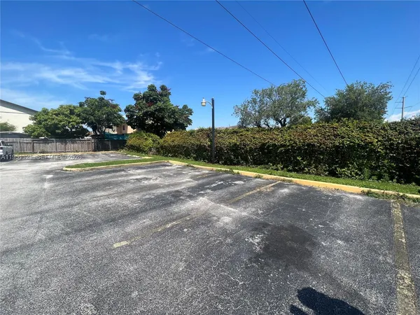 a view of a field with trees in the background