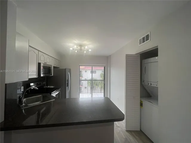 a kitchen with counter top space cabinets and appliances