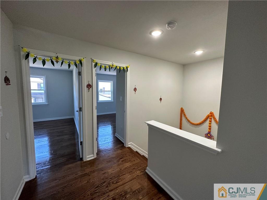 4102 Hana Road Edison, NJ 08817 - Photo 22 of 40 a view of a hallway with wooden floor and stairs