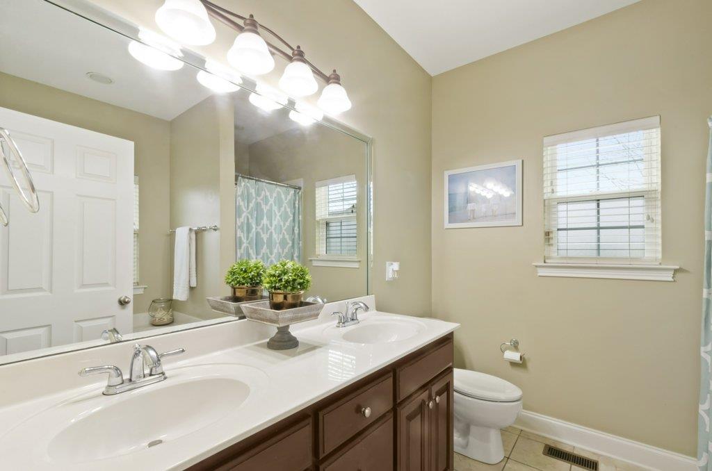 619 Lee Road Lebanon, TN 37087 - Photo 9 of 19 a bathroom with a double vanity sink toilet and a mirror