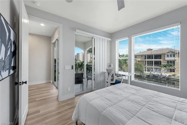 a bedroom with a large bed and a large window