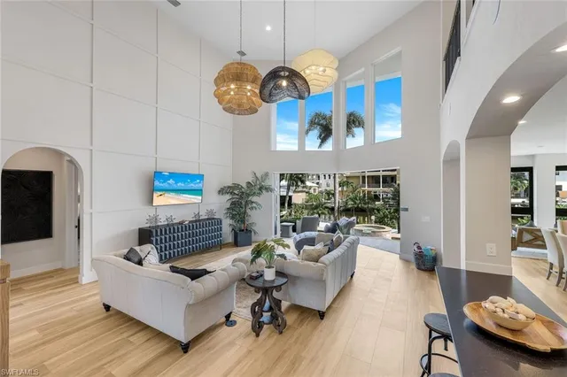 a living room with fireplace furniture and a floor to ceiling window