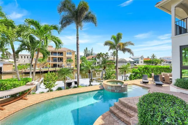 a view of a swimming pool with a patio and a garden