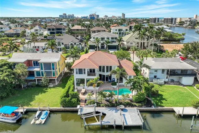 an aerial view of a house with a garden and lake view