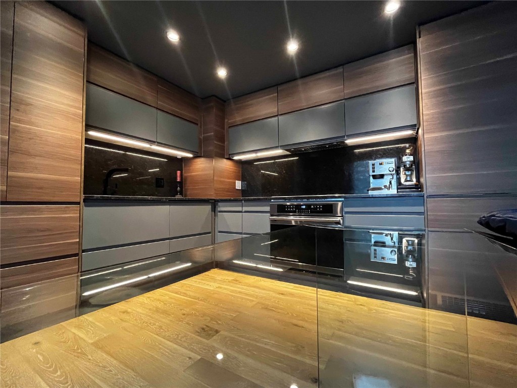 a kitchen with stainless steel appliances wooden cabinets and a stove