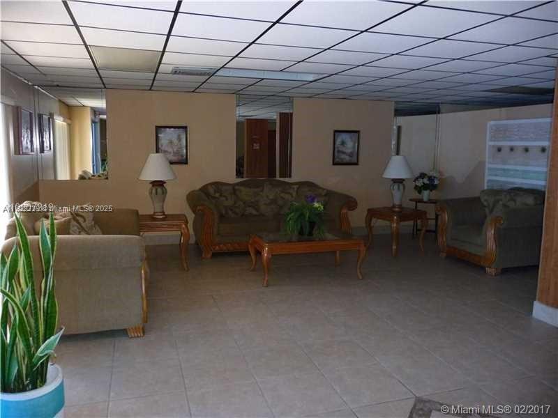2200 East Hallandale Beach Boulevard, Unit 708 Hallandale Beach, FL 33009 - Photo 12 of 14 a living room with furniture and a potted plant