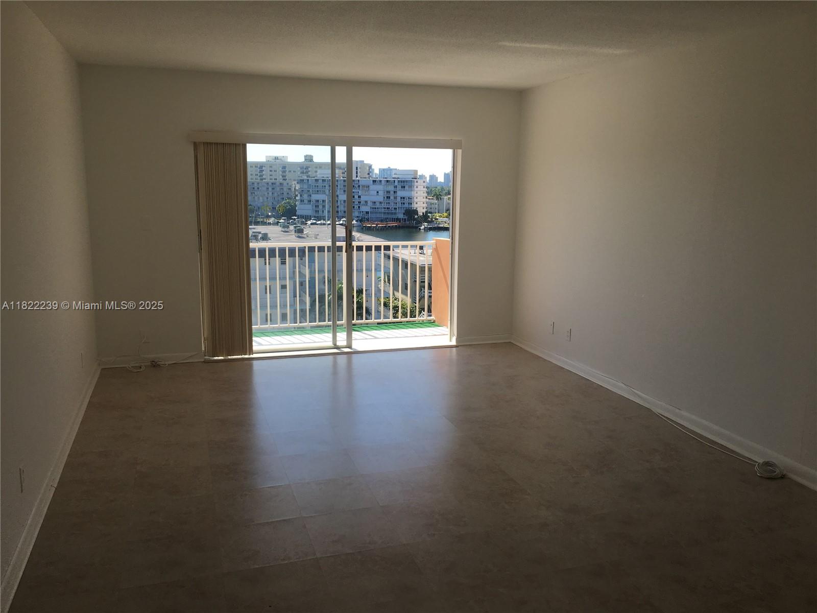 2200 East Hallandale Beach Boulevard, Unit 708 Hallandale Beach, FL 33009 - Photo 2 of 14 a view of a livingroom with wooden floor and a window