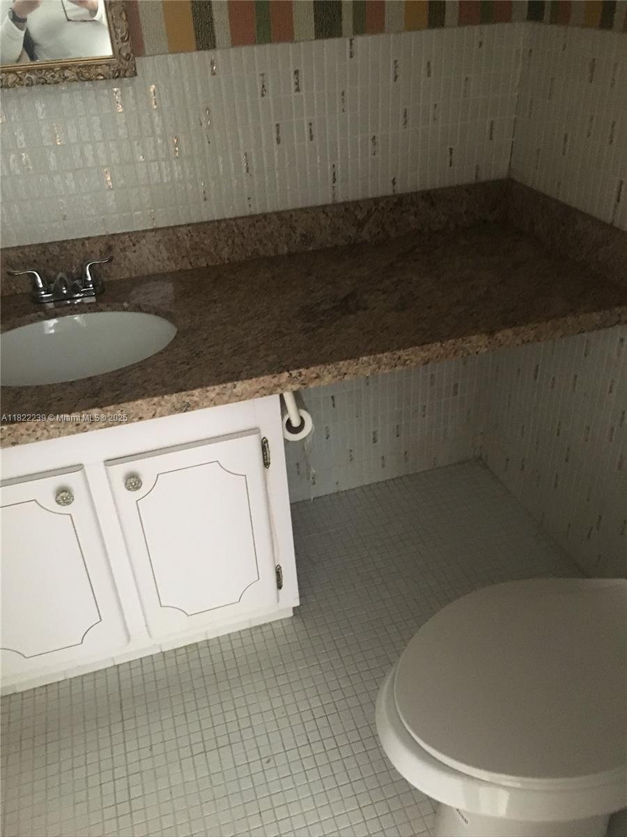 2200 East Hallandale Beach Boulevard, Unit 708 Hallandale Beach, FL 33009 - Photo 10 of 14 a utility room with a sink