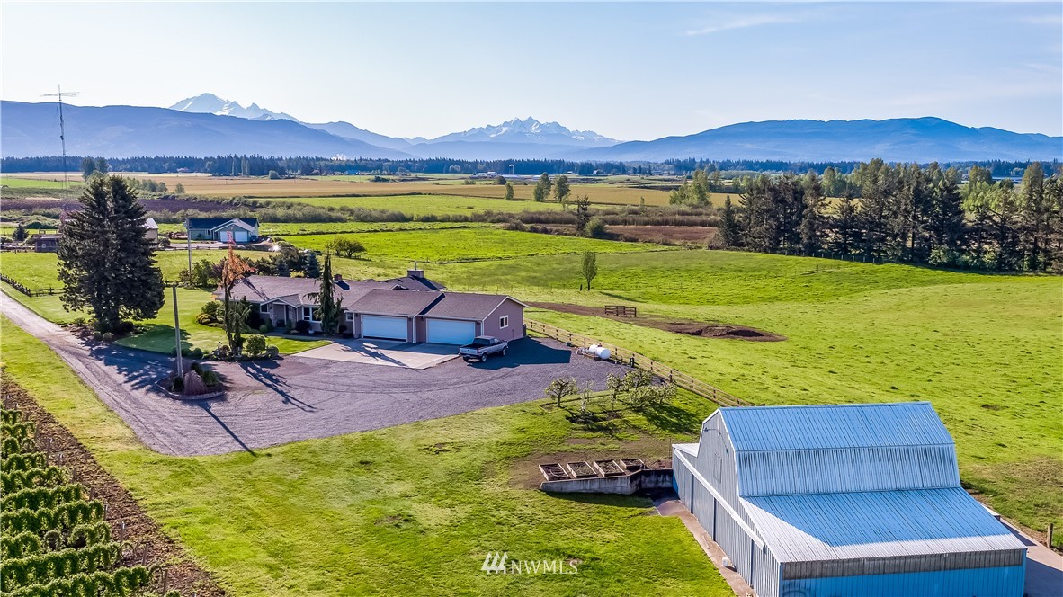 7351 Thiel Road Lynden, WA 98264 - Photo 1 of 33 a view of swimming pool with a table and chairs under an umbrella
