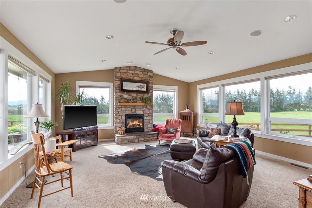7351 Thiel Road Lynden, WA 98264 - Photo 11 of 33 a living room with furniture fireplace and a large window