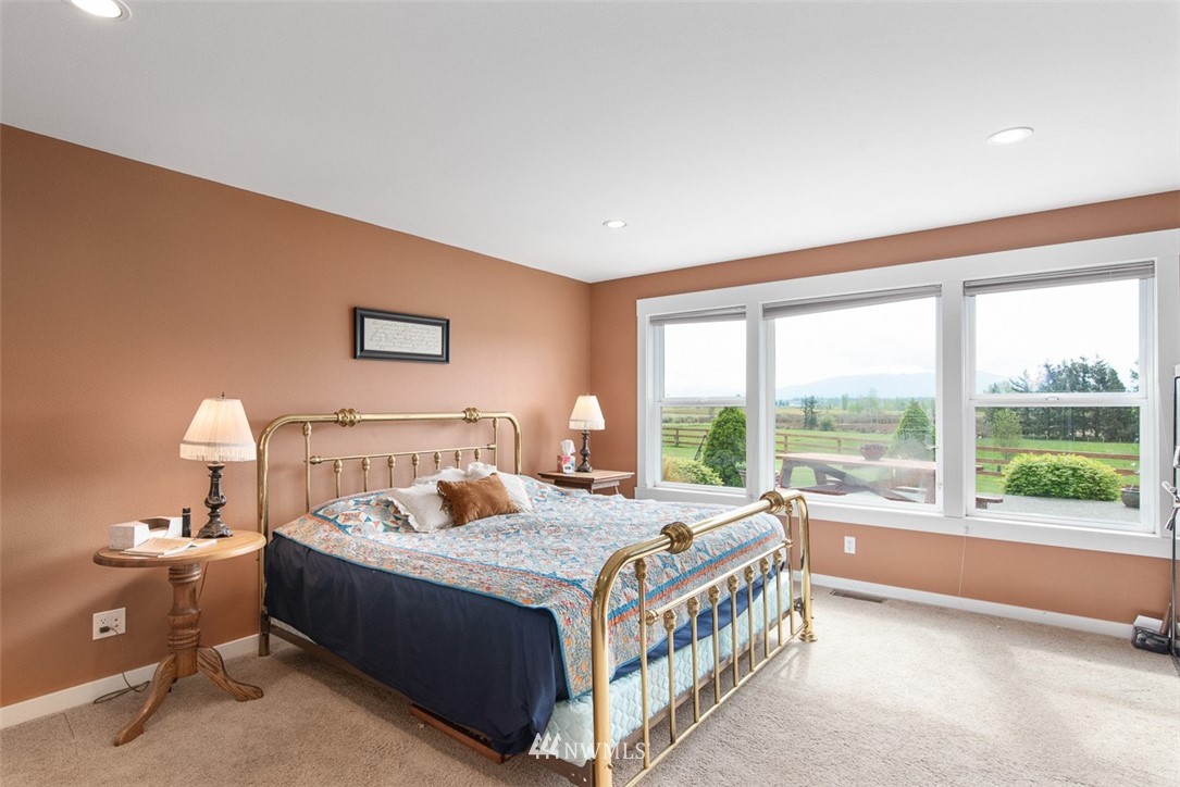 7351 Thiel Road Lynden, WA 98264 - Photo 13 of 33 a bedroom with a bed and a large window