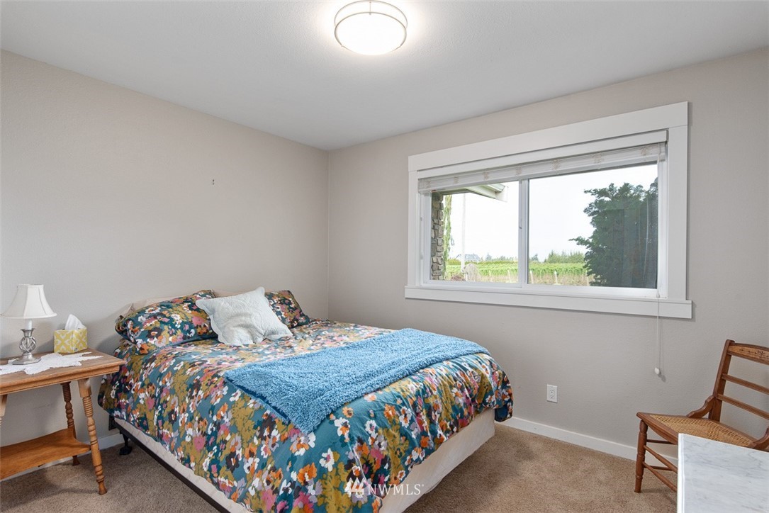 7351 Thiel Road Lynden, WA 98264 - Photo 17 of 33 a bedroom with a bed and window