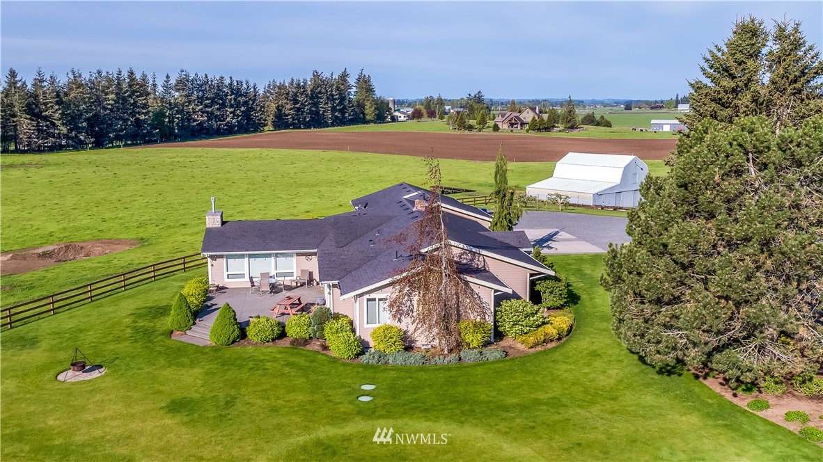 7351 Thiel Road Lynden, WA 98264 - Photo 3 of 33 a aerial view of a house with a big yard and large trees