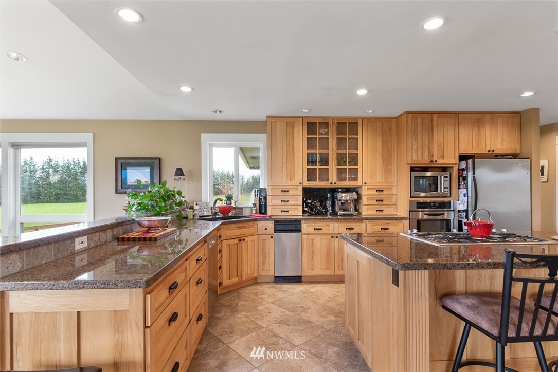 7351 Thiel Road Lynden, WA 98264 - Photo 10 of 33 a kitchen with stainless steel appliances granite countertop a sink stove and refrigerator