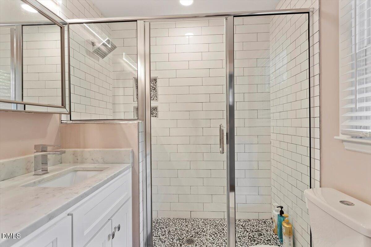 2120 Hillock Drive Raleigh, NC 27612 - Photo 27 of 29 a bathroom with a shower and a sink