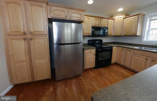 a kitchen with a refrigerator stove and microwave