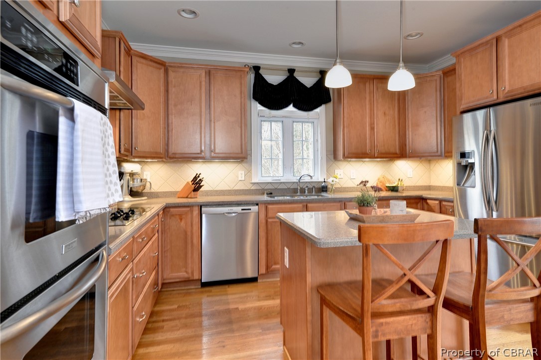 3165 Ridge Drive Toano, VA 23168 - Photo 12 of 41 The kitchen features a center island, stainless appliances, and hardwood floors.