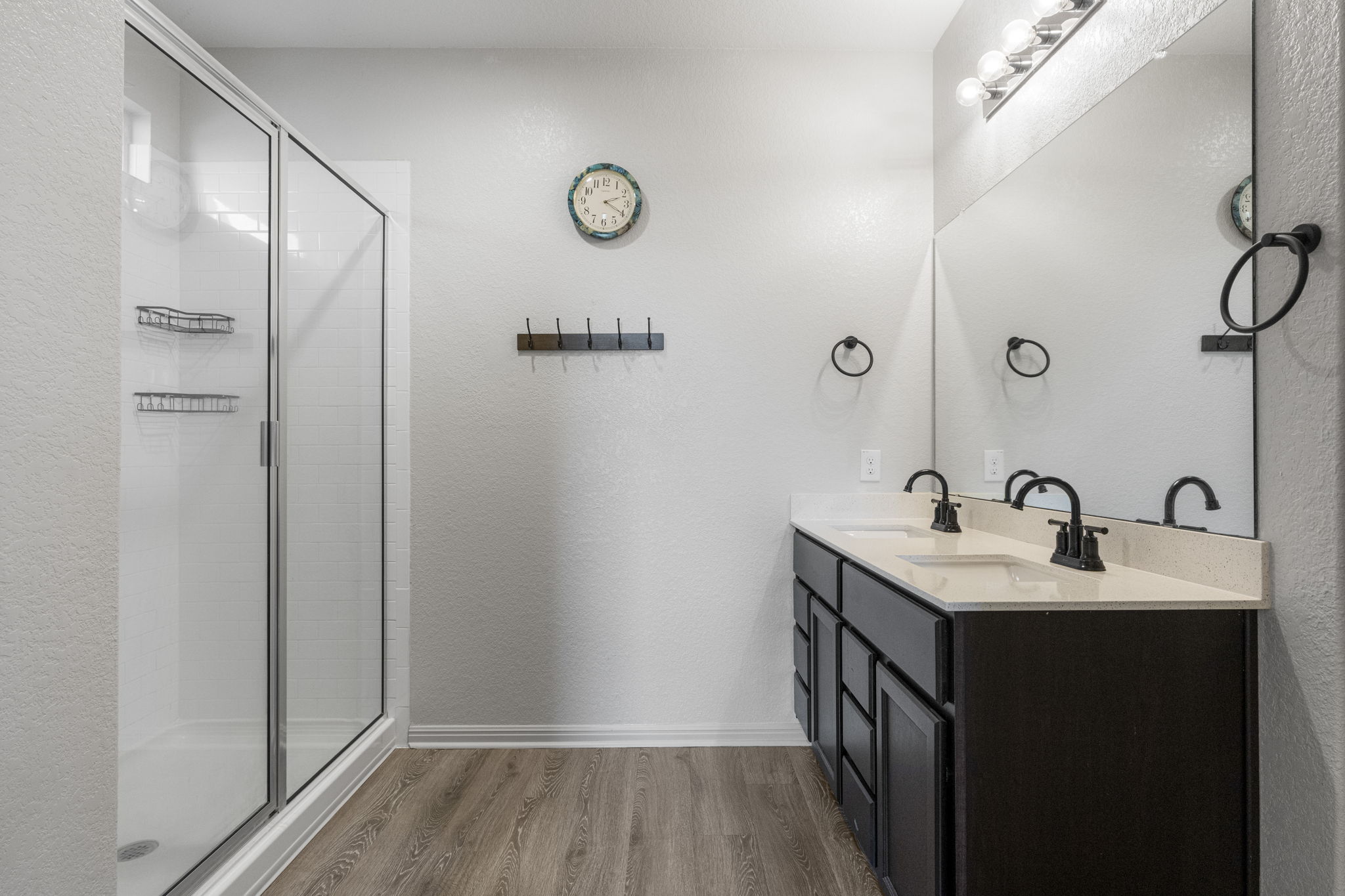 185 Struss Drive Georgetown, TX 78626 - Photo 14 of 23 The bathroom presents a double vanity with ample counter space and a sleek glass-enclosed shower.
