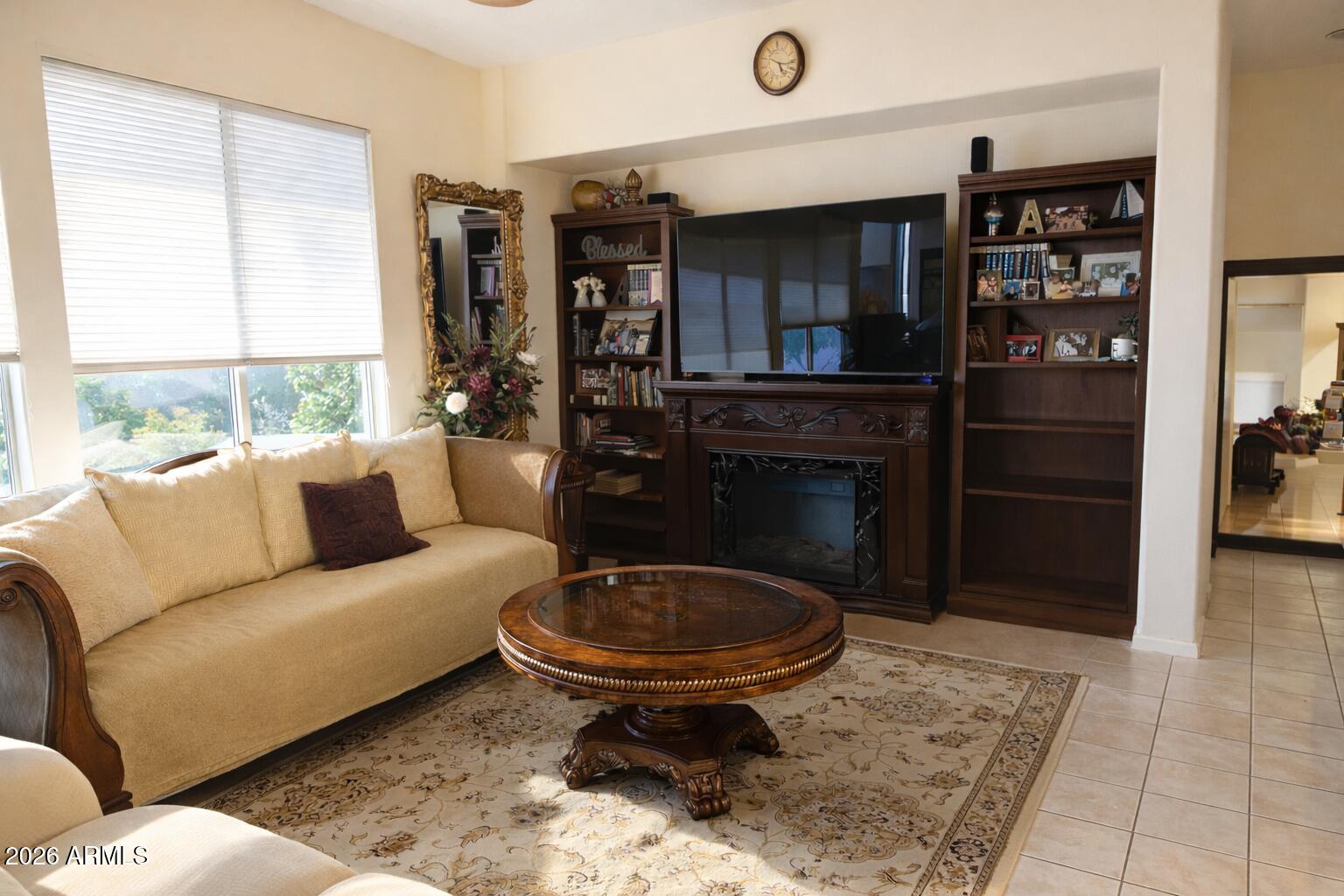 783 South Longmore Street Chandler, AZ 85224 - Photo 2 of 12 a living room with furniture a rug and a fireplace