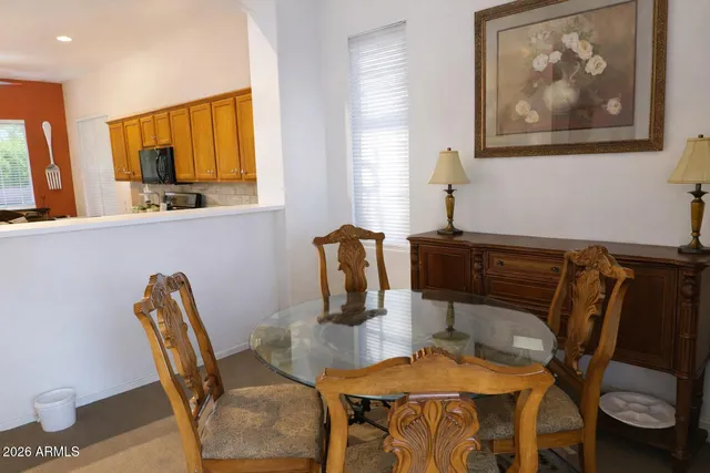a dining room with furniture and wooden floor