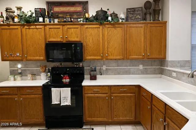 a kitchen with stainless steel appliances granite countertop a sink a stove and a microwave