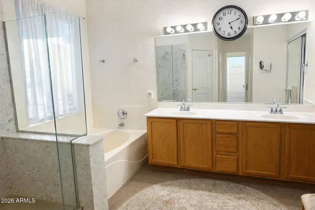 a spacious bathroom with a double vanity sink and a mirror