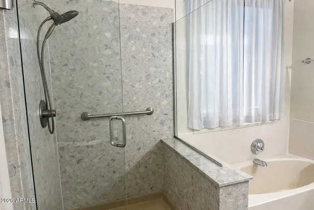 a bathroom with a shower and a sink