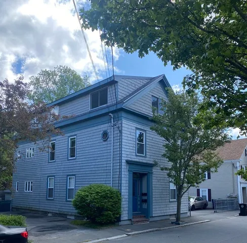 a view of a house with a tree