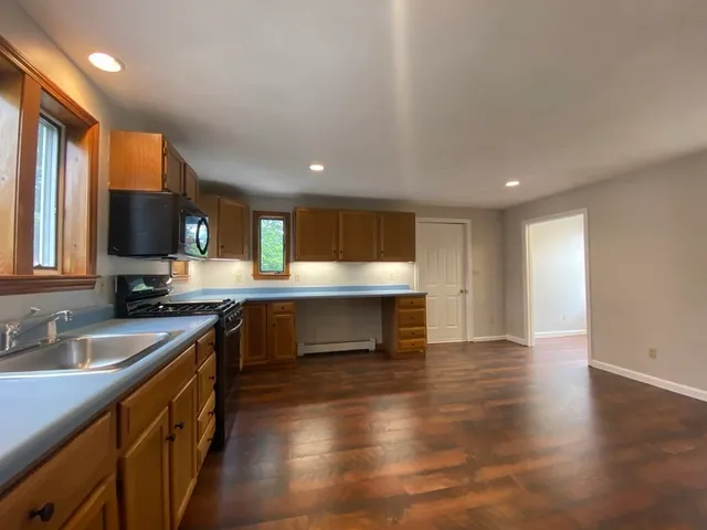 a kitchen with a sink cabinets and appliances